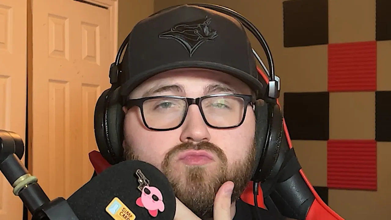 streamer rubbing chin with kirby pin on mic